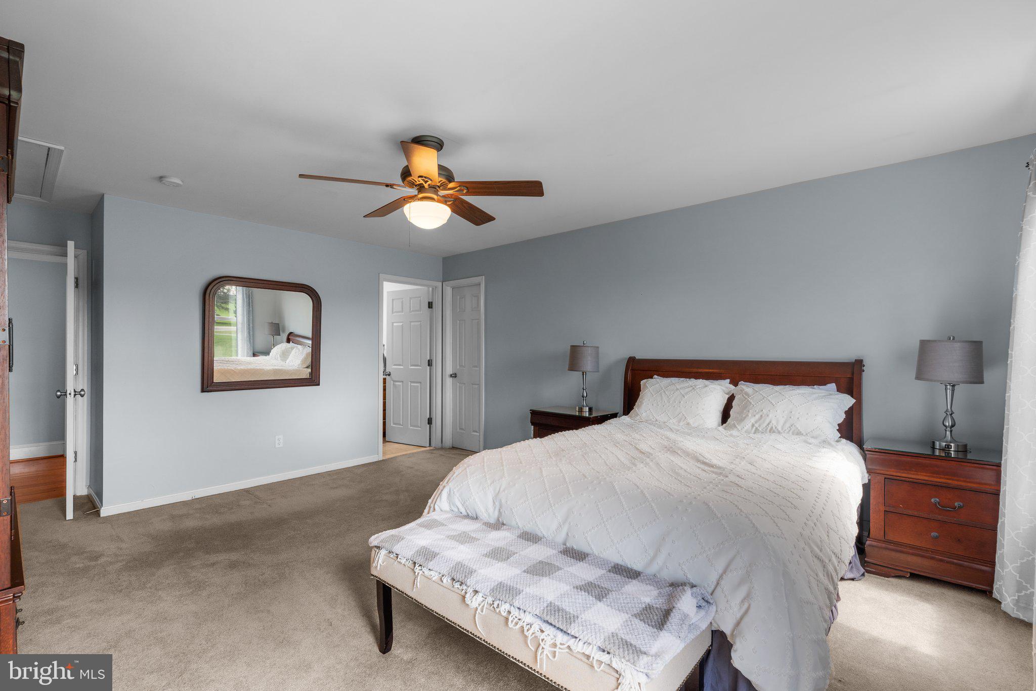 10855 Bethesda Church Road Damascus, MD 20872 - Photo 55 of 92 a bedroom with a bed and a chandelier