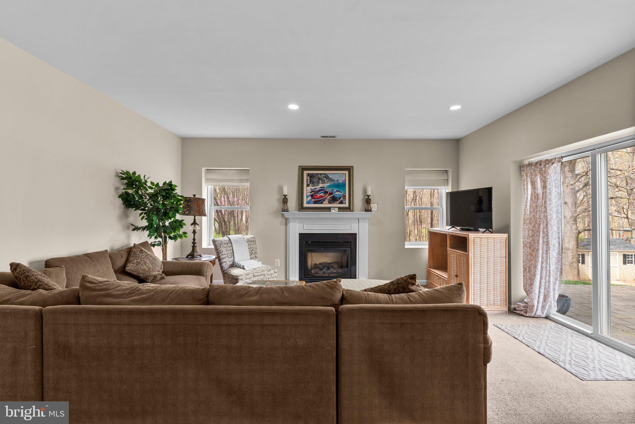 10855 Bethesda Church Road Damascus, MD 20872 - Photo 61 of 92 a living room with furniture and a flat screen tv