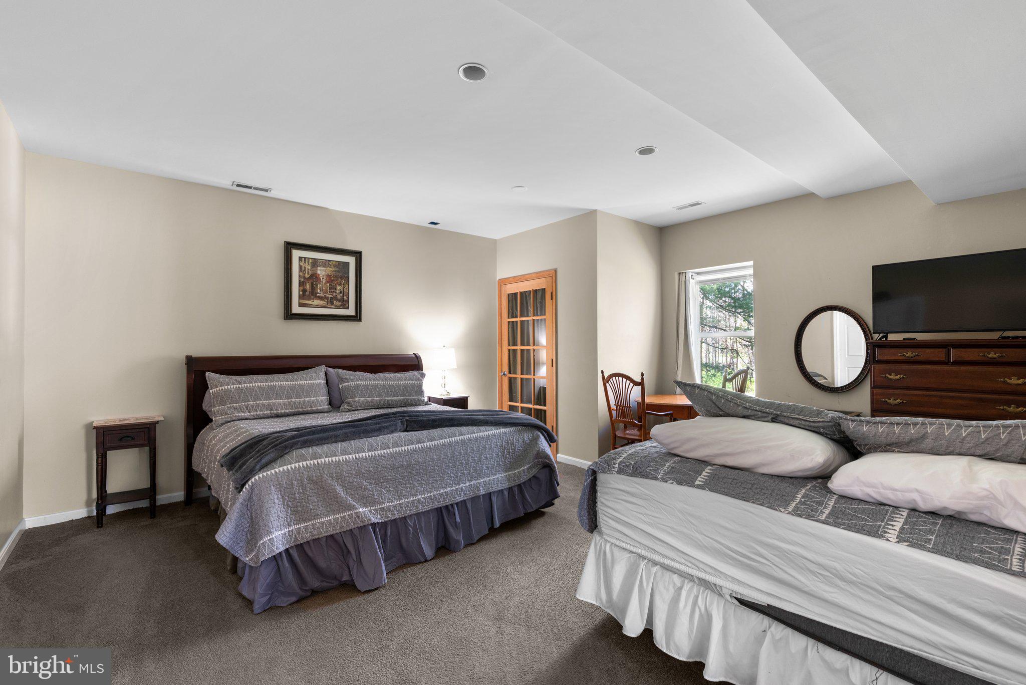 10855 Bethesda Church Road Damascus, MD 20872 - Photo 66 of 92 a spacious bedroom with two beds and a window