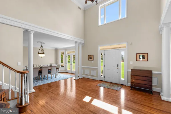 a view of a dining room with furniture wooden floor and chandelier
