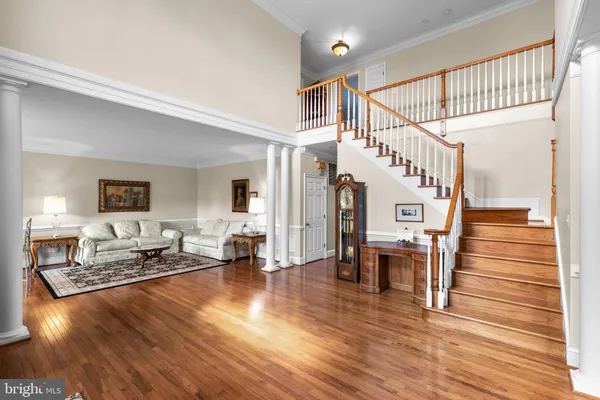 a kitchen with granite countertop a table chairs stainless steel appliances and wooden floor