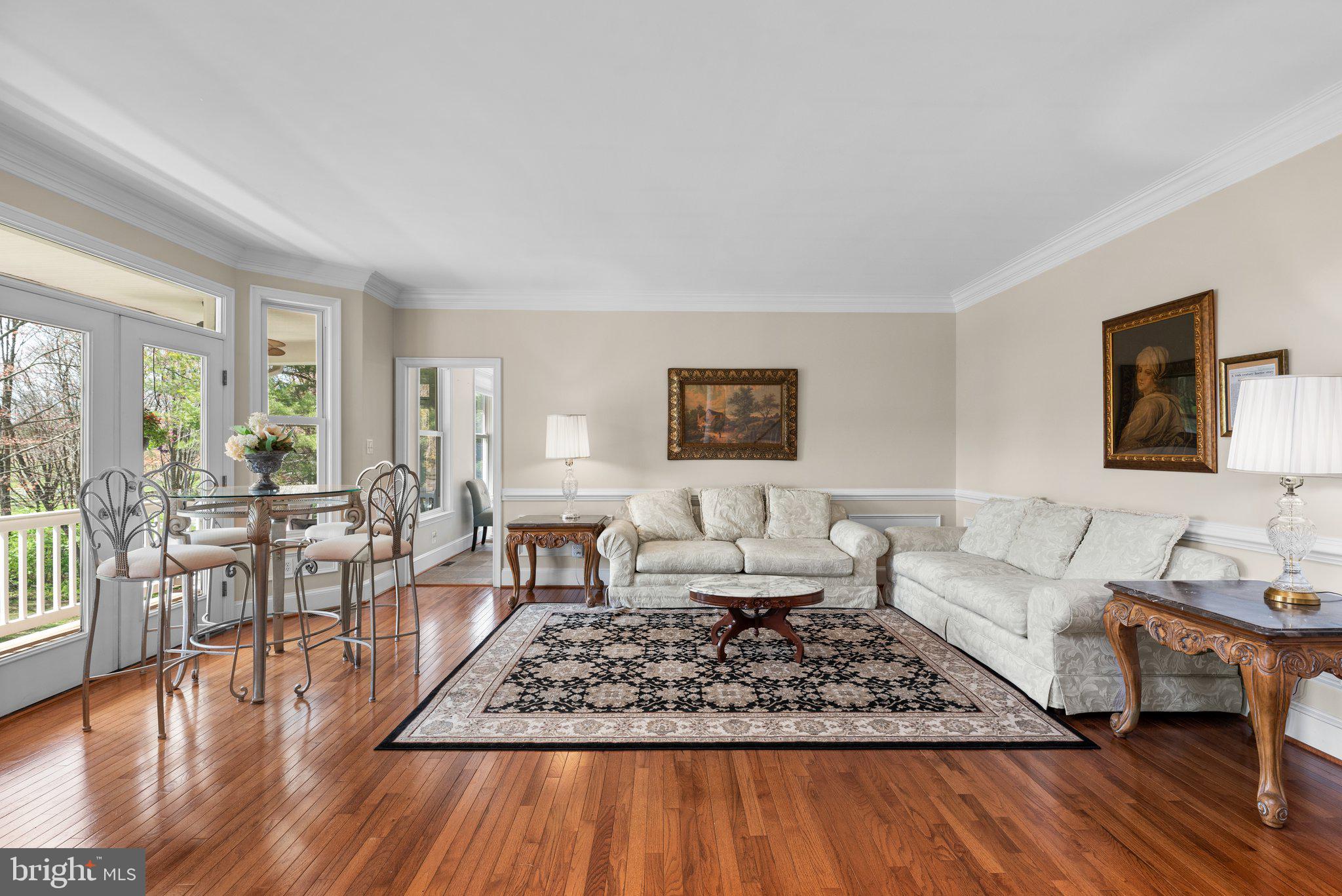 10855 Bethesda Church Road Damascus, MD 20872 - Photo 9 of 92 a living room with furniture a rug wooden floor and a large window