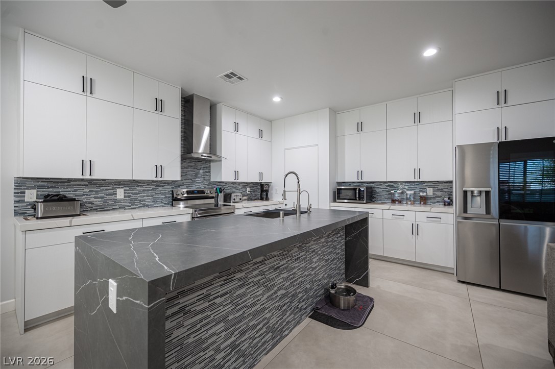 441 Belville Road Pahrump, NV 89048 - Photo 13 of 44 Culinary delights await in this modern kitchen featuring a central island and sleek stainless steel appliances.