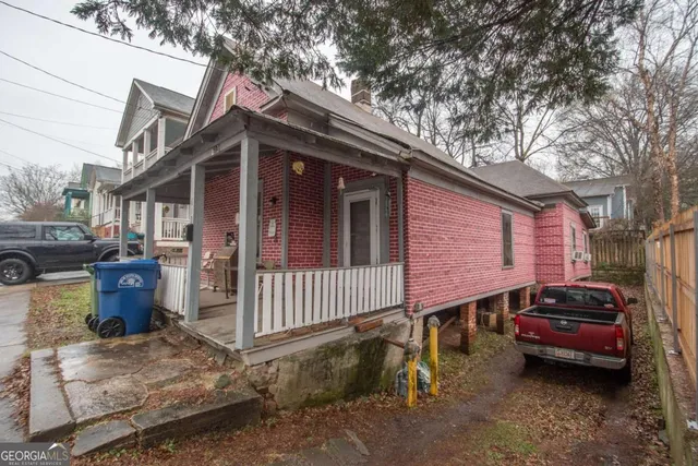 a view of a house with a yard and sitting area
