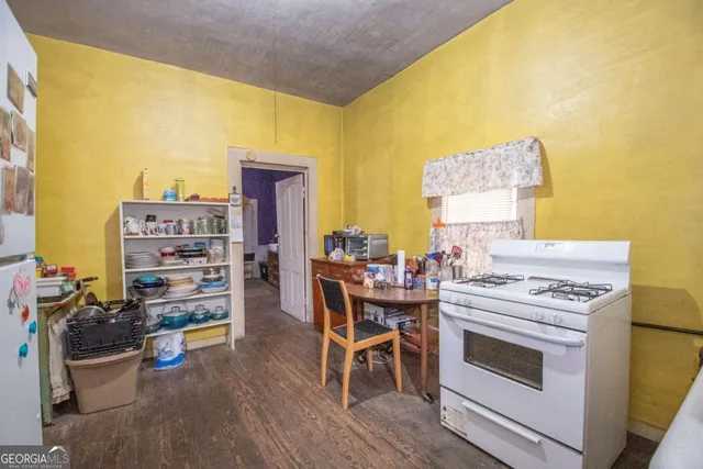 a view of a dining room with chairs and wooden floor