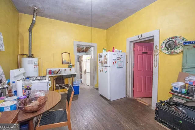 a living room with furniture and a dining table