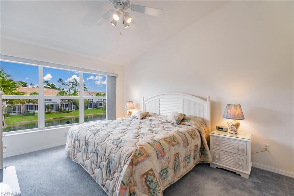 15451 Marcello Circle, Unit 229 Naples, FL 34110 - Photo 16 of 30 a bed sitting in a bedroom next to a window