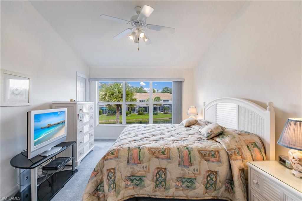 15451 Marcello Circle, Unit 229 Naples, FL 34110 - Photo 17 of 30 a bed sitting in a bedroom next to a window