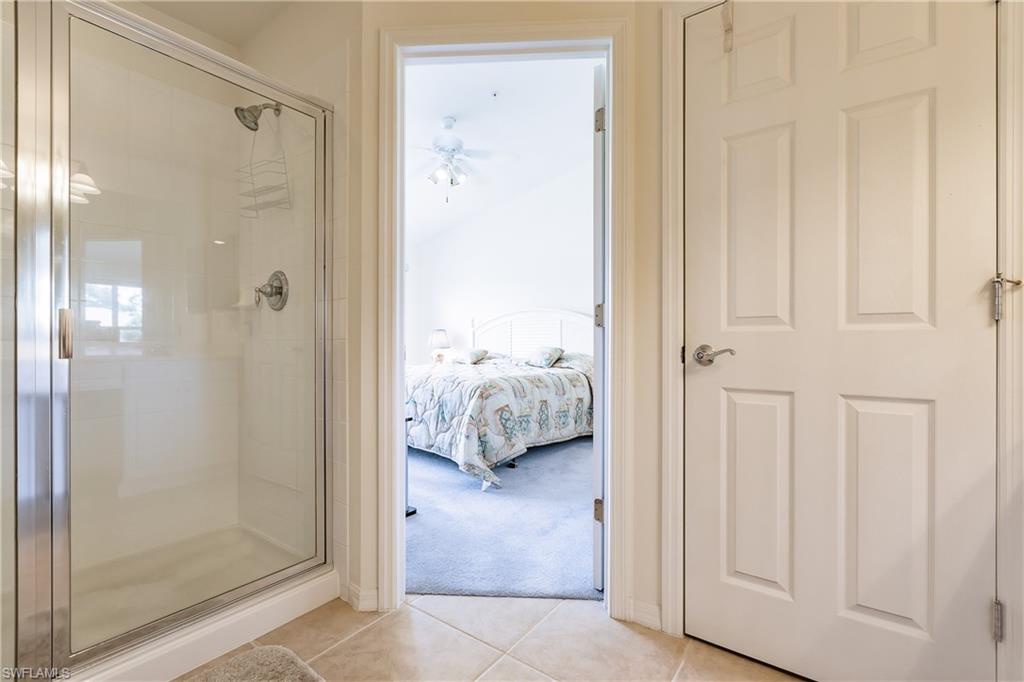 15451 Marcello Circle, Unit 229 Naples, FL 34110 - Photo 20 of 30 a en suite bathroom with a shower