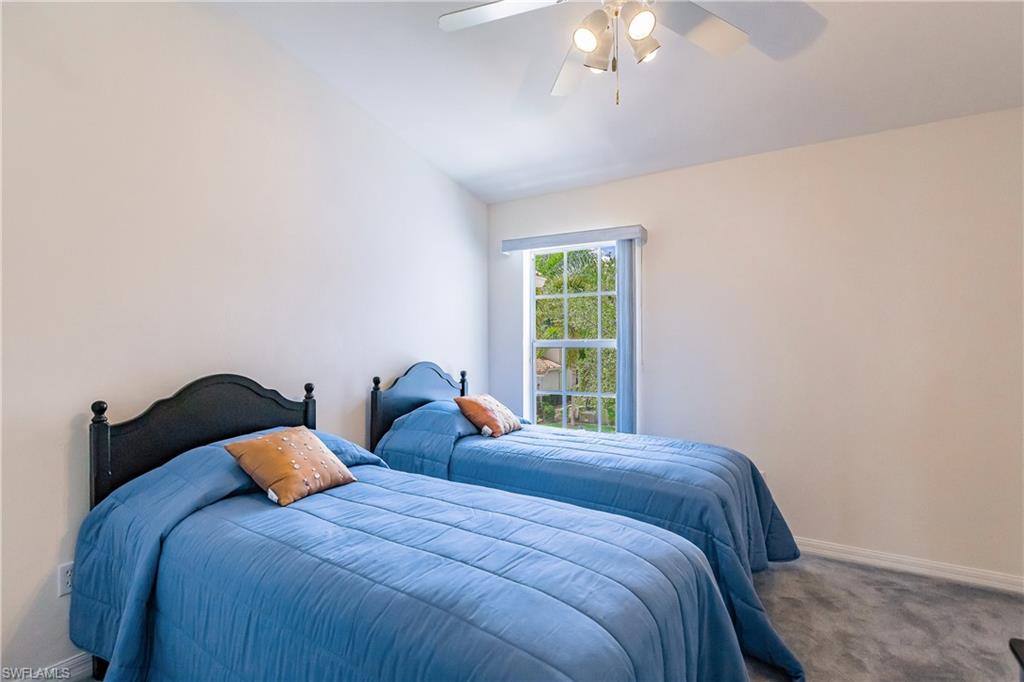 15451 Marcello Circle, Unit 229 Naples, FL 34110 - Photo 21 of 30 a bed sitting in a bedroom next to a window
