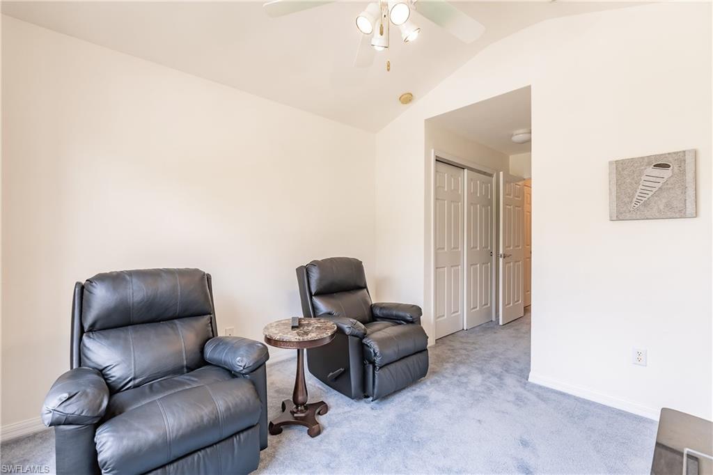15451 Marcello Circle, Unit 229 Naples, FL 34110 - Photo 24 of 30 a living room with furniture