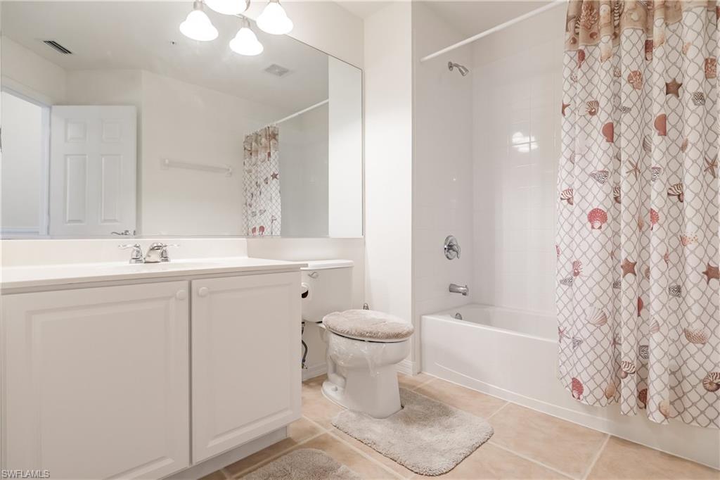 15451 Marcello Circle, Unit 229 Naples, FL 34110 - Photo 25 of 30 a bathroom with a sink toilet and shower