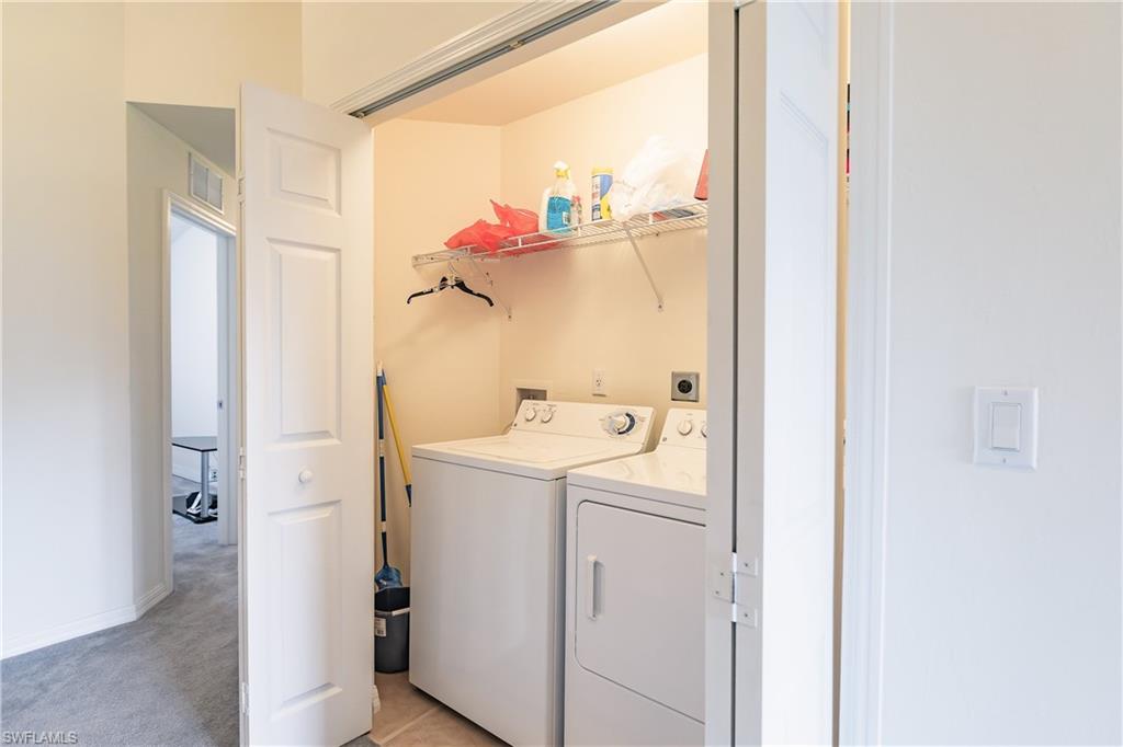 15451 Marcello Circle, Unit 229 Naples, FL 34110 - Photo 26 of 30 a view of bathroom with a washer and dryer