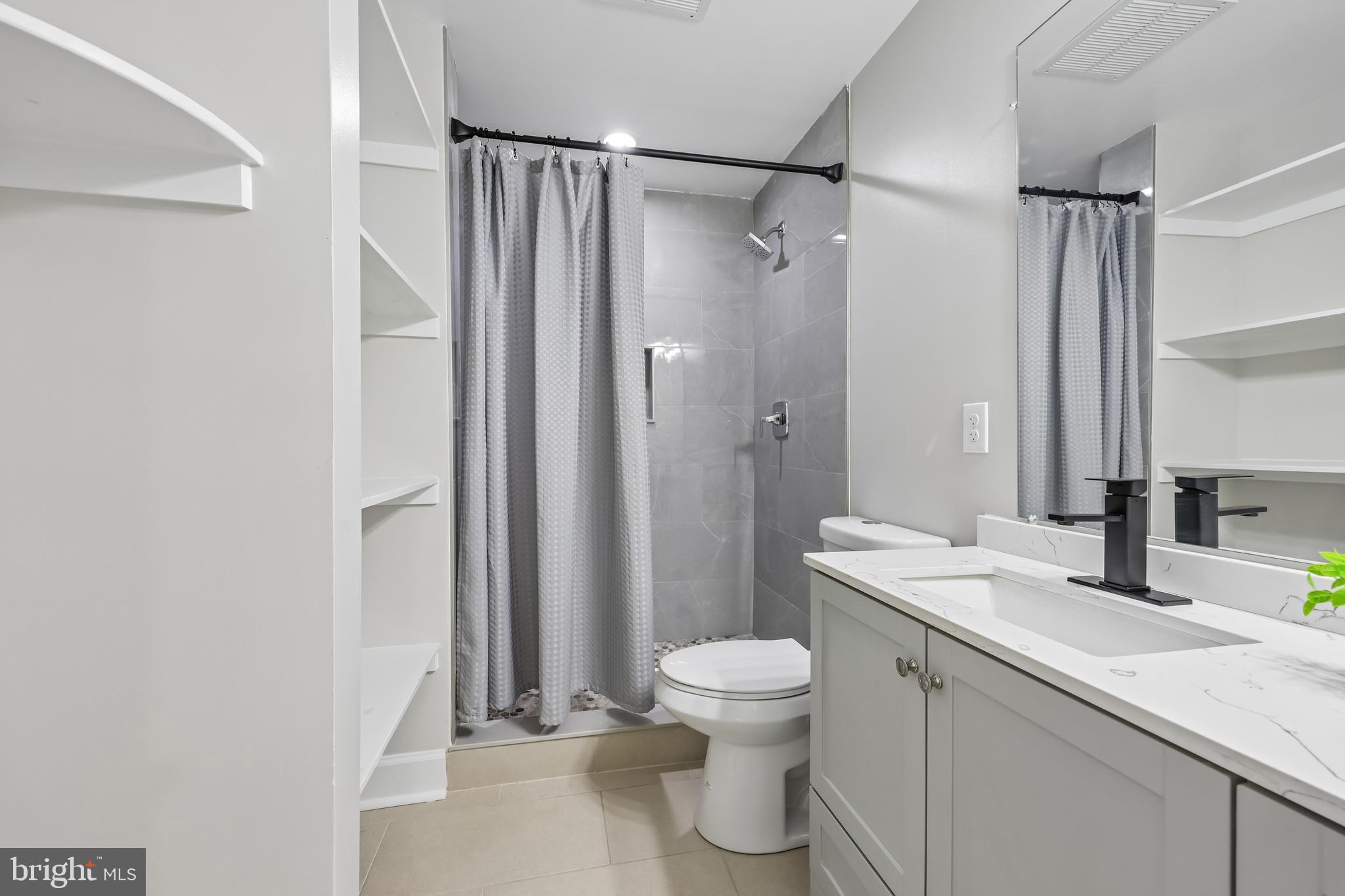 12304 Popes Head Road Fairfax, VA 22030 - Photo 61 of 78 a bathroom with a sink a toilet and shower