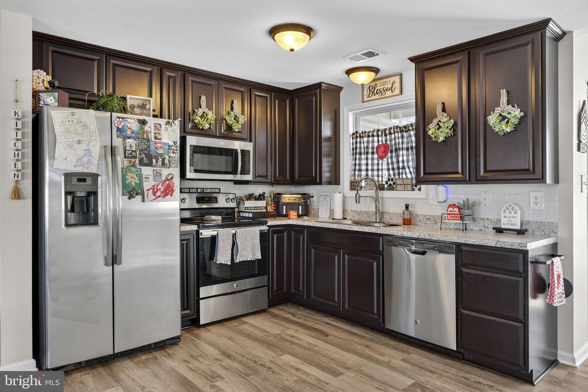 37 Knowledge Court Inwood, WV 25428 - Photo 17 of 53 a kitchen with stainless steel appliances granite countertop a refrigerator and a stove top oven