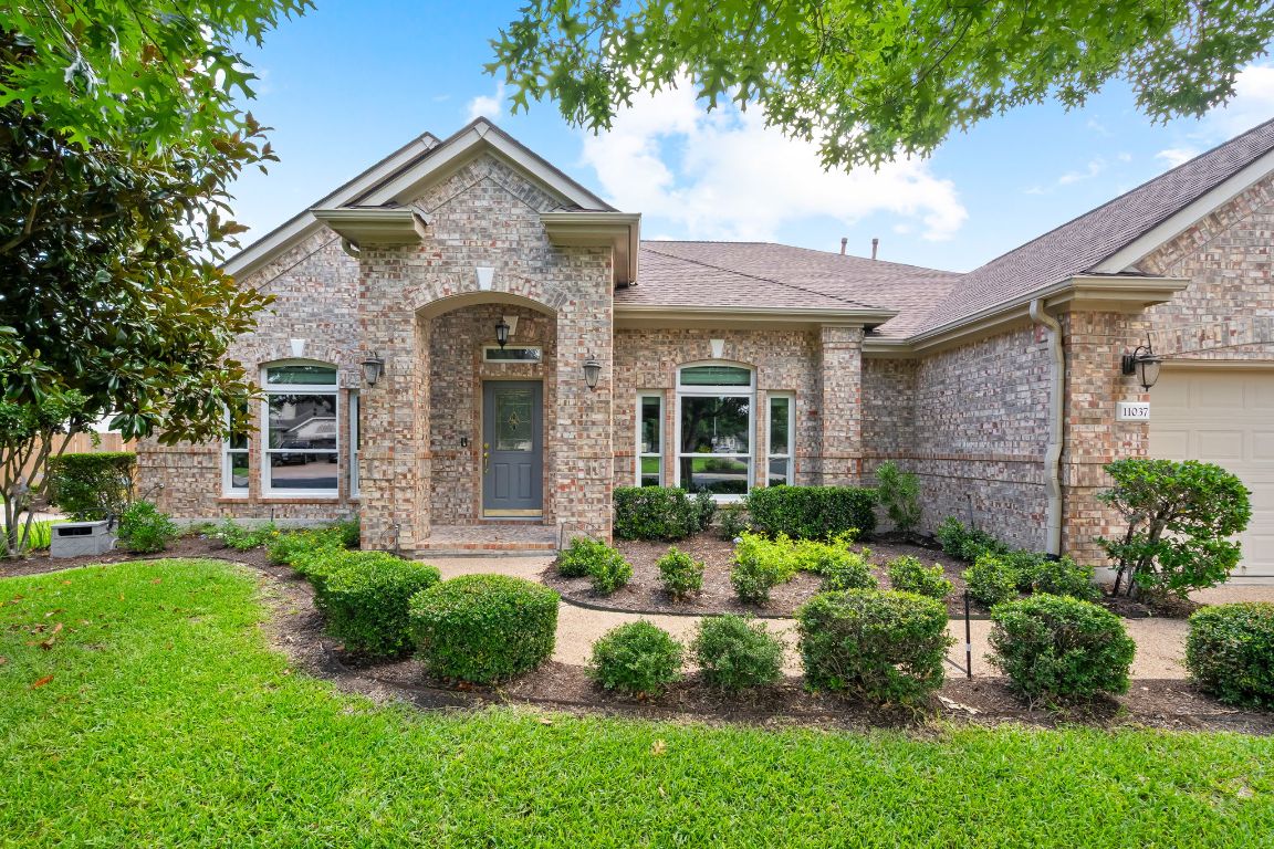 11037 River Plantation Drive Austin, TX 78747 - Photo 1 of 1 a front view of a house with garden