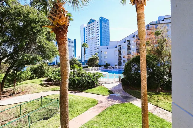 a view of a white house with a yard