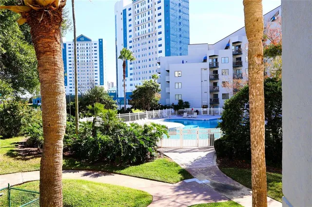 a living room with furniture a large window and kitchen view