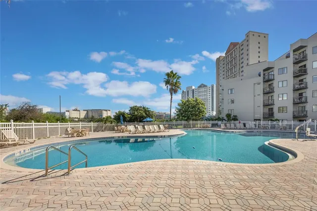 a view of a swimming pool with outdoor seating