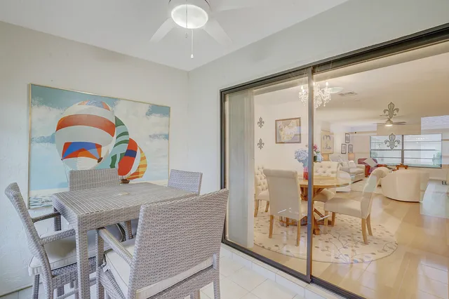 a view of a dining room with furniture and a floor to ceiling window