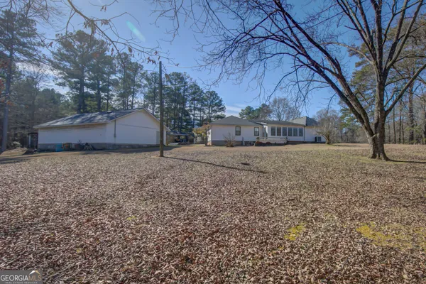 a view of a yard with a house and trees