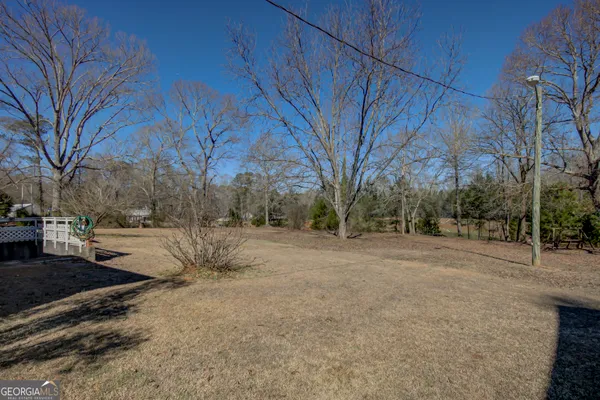 a view of dirt yard with a house
