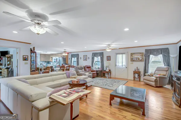 a living room with furniture and wooden floor