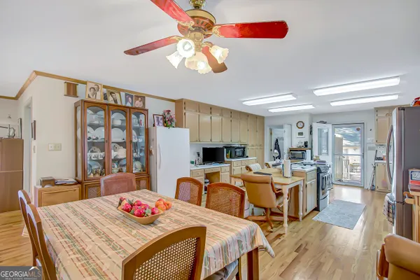 a view of a dining room with furniture a chandelier and wooden floor