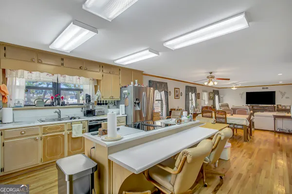 a kitchen with a table chairs stove and cabinets