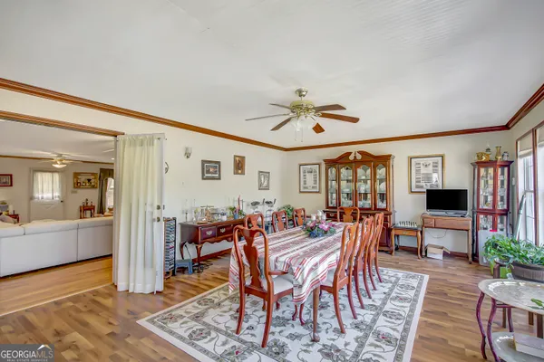 a view of a dining room with furniture window and wooden floor