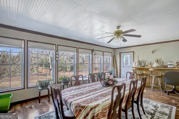 a view of a dining room with furniture window and wooden floor