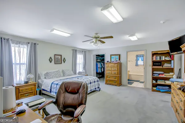 a bedroom with a bed and furniture