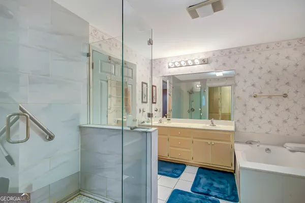 a bathroom with a sink a mirror and a bathtub
