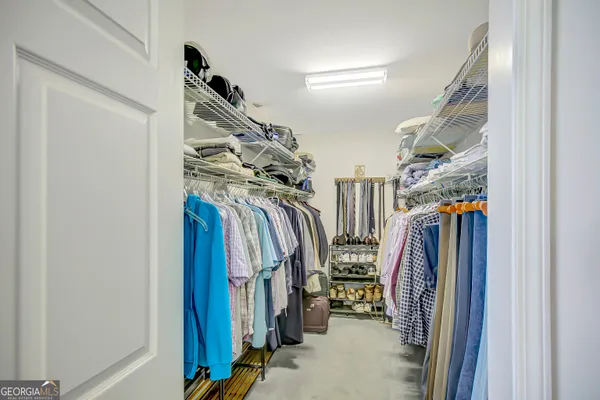 a view of walk in closet with clothes