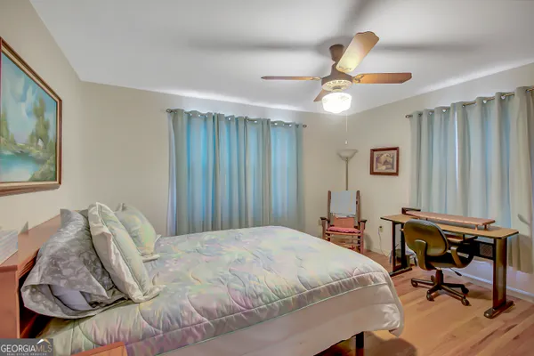 a bedroom with a bed and a desk