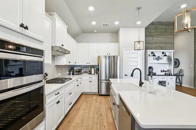 a kitchen with a sink stove and refrigerator