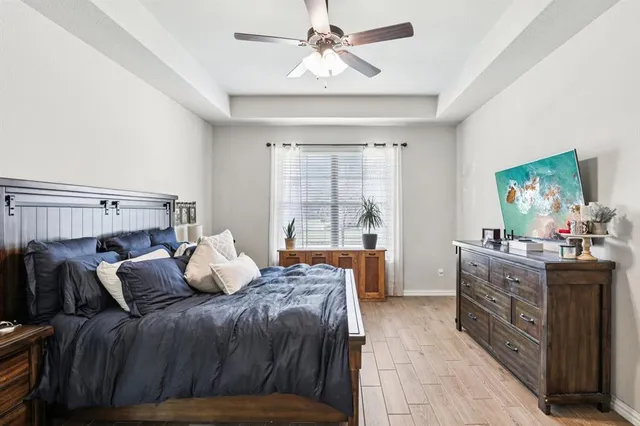 a bedroom with a bed and a chandelier