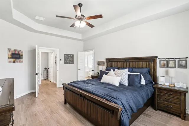 a bedroom with bed and wooden floor