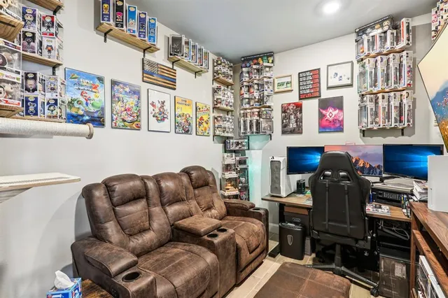 a couch sitting in a living room next to a book shelf