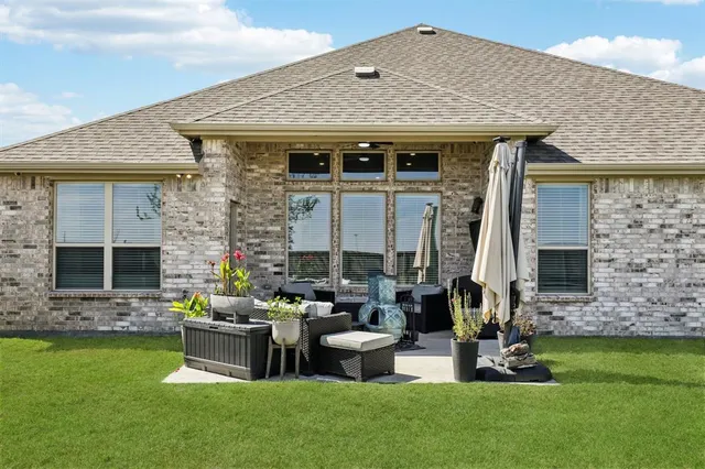 a front view of house with outdoor seating and barbeque oven