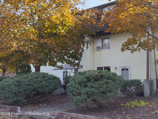 a view of a house with a tree