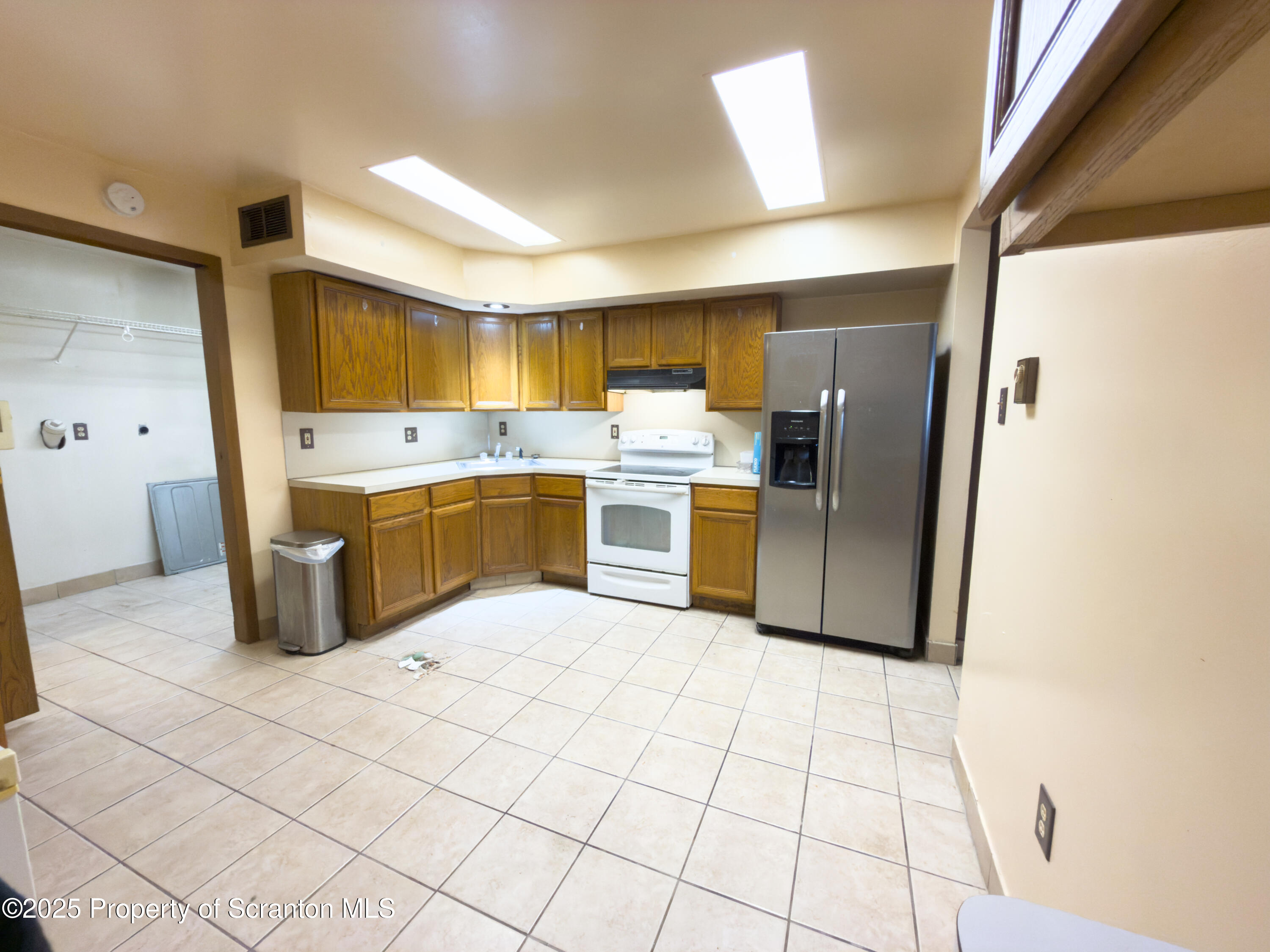 526 Langan Road, Unit G Pittston, PA 18640 - Photo 3 of 8 a kitchen with stainless steel appliances a refrigerator sink and cabinets
