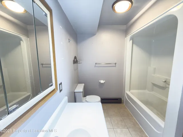 a bathroom with a tub and shower