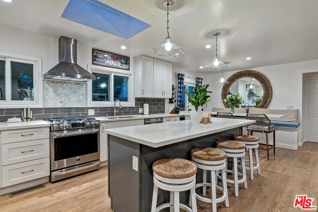 434 West Maple Avenue El Segundo, CA 90245 - Photo 12 of 29 a kitchen with a stove a sink a dining table and chairs