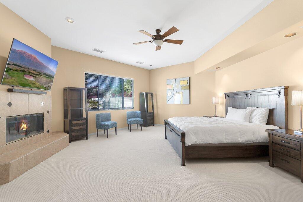 8 MacBeth Court Rancho Mirage, CA 92270 - Photo 21 of 46 a bedroom with a bed and a chandelier