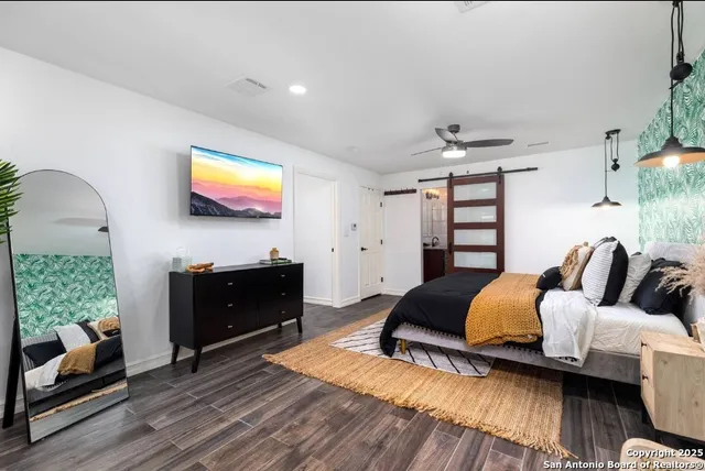 a bedroom with a bed and a couch