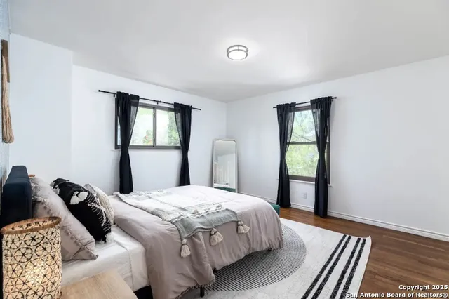 a bedroom with a bed and a large window