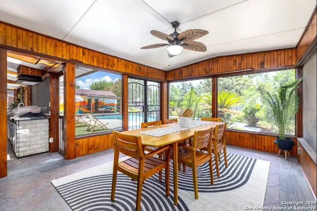 a dining room with furniture a chandelier and wooden floor