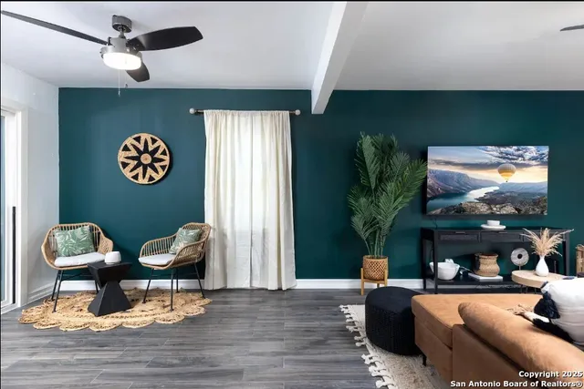 a living room with furniture a flat screen tv and a large window
