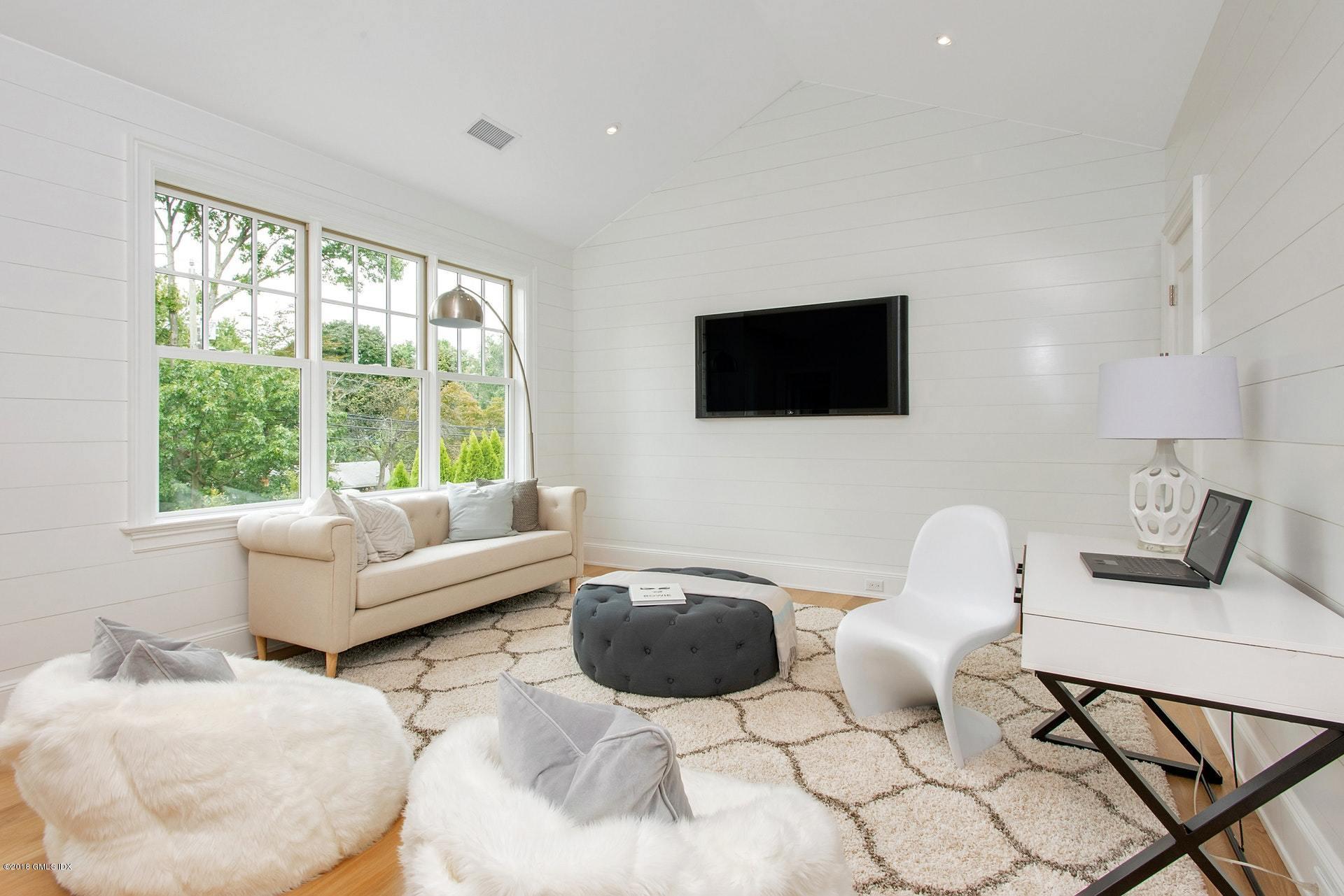 51 Sheep Hill Road Riverside, CT 06878 - Photo 15 of 36 a living room with furniture and a flat screen tv